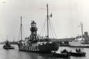 With two launches steadying her aft, the Smith's Knoll lightship is towed up river at Yarmouth by the tug Hector Read on March 17, 1966.