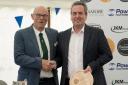 Customer quality manager, Jack Eade (R), receiving one of First Milk’s two trophies from Frome & Agricultural Cheese Show president, Michael Rogers (L)