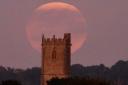 An image of the faded harvest supermoon eclipse pictured by St Mary's church in West Buckland.