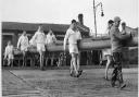 Rodney Dingle (front row, third from left) with the Cambridge crew, carrying their boat out before the 1952 Boat Race.