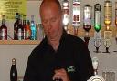 Peter Dellar pulls a pint at the club.