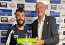 Exmouth Town's Callum Shipton receives his man of the match award from John Dibsdall