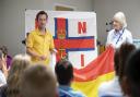 RNLI staff teaching South West kids about beach safety as a part of their ‘Meet the Lifeguard’ programme.