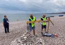 Lions Alan Lowe and Gavin March measuring an entry in the Pebble Building Competition