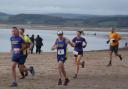 Winning Woman Claire Stone in the 1st mile on the beach