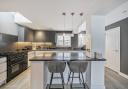 The finely-appointed kitchen has a sleek, contemporary look