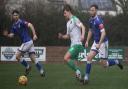 Exmouth's Michael Landricombe chases after Bashley's Ashton Pickles