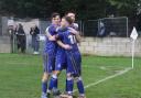 Joe Belsten, who scored the winner from the penalty spot, celebrates his goal with Ben Steer (left) and captain Ethan Slater