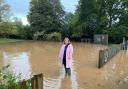 Cllr Jess Bailey in floodwater in Tipton St John.