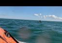 Windsurfer Carl Sawyer out at sea as the lifeboat approaches him