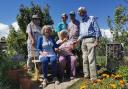 Budleigh Community Allotment team receiving the cheque