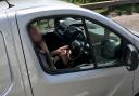 Shocking footage shows man trimming his beard while driving on a motorway