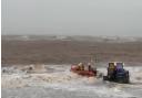 A group of three volunteers from the RNLI helped bring two wing surfers to safety.