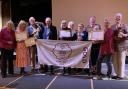 Exmouth in Bloom Committee members with their haul of awards and the GOLD flag for 2024