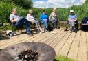 Age UK Devon group enjoying campfire cooking at Seaton Wetlands