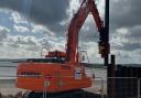 Steel pile wall installation on Exmouth seafront, near sideshore, April 2024.