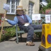 A scarecrow with a message at a previous festival