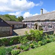 This handsome chocolate-box thatched cottage is sited in the Farway Valley