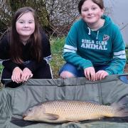 Summer Skelly and Evie Stewart with a mid double figure common carp from Newbarn