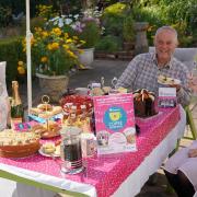 A family holding a Hopiscare coffee morning