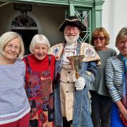 Exmouth town crier Roger Bourgein with, left to right, artists Bente Kumar, June Murrell, Debbie Coles and Zan Nye