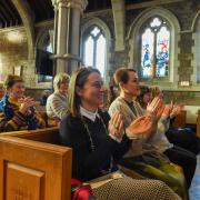 The crowd at Budleigh Salterton Literary festival applaud their next speaker.