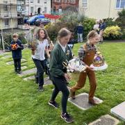 The prizewinners parade outside the museum with their crowns