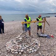 Lions Alan Lowe and Gavin March measuring up at the pebble building competition