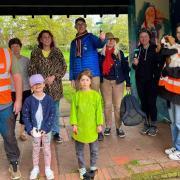 Volunteers helping draw art on the Phear Park shelter.