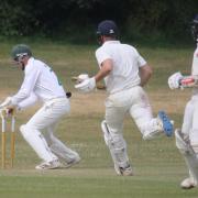 Sidmouth wicketkeeper Robbie Powell removes the bails as Dan Pyle is run out