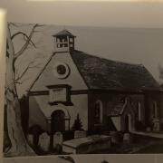 Old photo of St Michael’s and All Angels Church with Sir John's tomb in the foreground