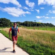 Isaac running in a weighted vest as part of his Ironman training