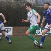 Exmouth's Michael Landricombe chases after Bashley's Ashton Pickles