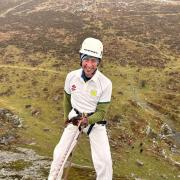 Abseiler in cricket whites