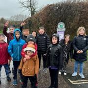 Smiling despite the rain - the under-8s team on their sponsored walk