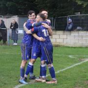 Joe Belsten, who scored the winner from the penalty spot, celebrates his goal with Ben Steer (left) and captain Ethan Slater