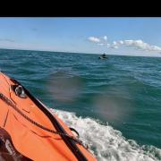 Windsurfer Carl Sawyer out at sea as the lifeboat approaches him