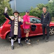 Town crier Roger Bourgein and deputy mayor Steve Gazzard at the car wash