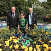 (left to right) Peter Farley, Lewis Gale, Dave Josey and the floral tribute