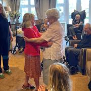 Molly dancing with a resident during her visit