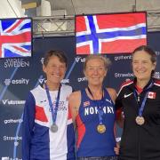 Jenny Reay on the podium with her World Masters W65 5,000m Silver Medal