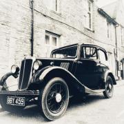 A vintage car in front of the Archway building in Axminster.