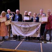 Exmouth in Bloom Committee members with their haul of awards and the GOLD flag for 2024