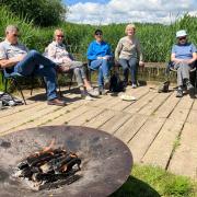 Age UK Devon group enjoying campfire cooking at Seaton Wetlands