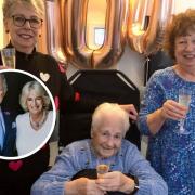 Doris celebrating her 100th with glass of fizz and a royal telegram from the King