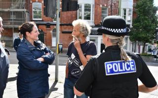 The commissioner speaks to a resident about their concerns