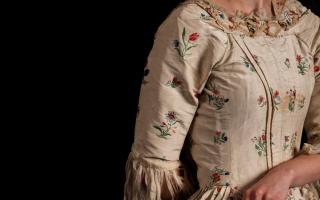 A late 18th century silk and floral embroidered open dress.